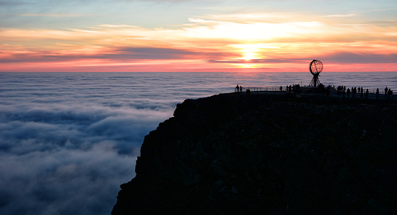 Midnight sun and clouds at the North Cape, Northern Norway. Composite photo