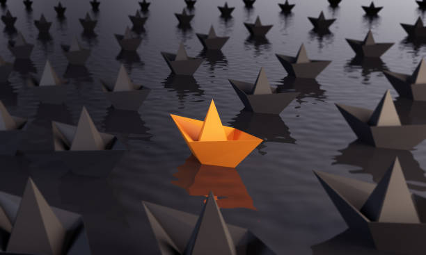 istock Standing Out From The Crowd With Paper Boats 936461540