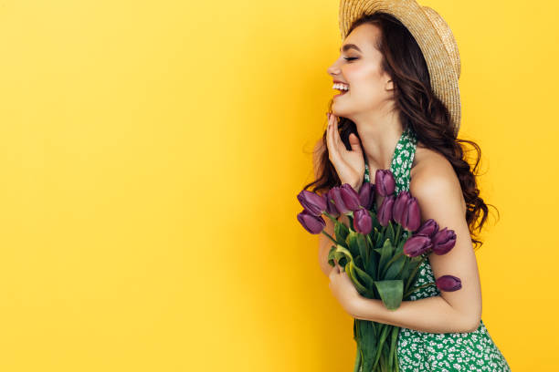 istock Lovely woman with yellow tulips bunch 936464856