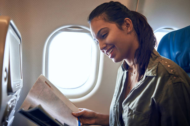 istock woman reading in the plane 936467626