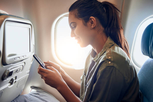 istock woman using her smartphone in the plane 936468042