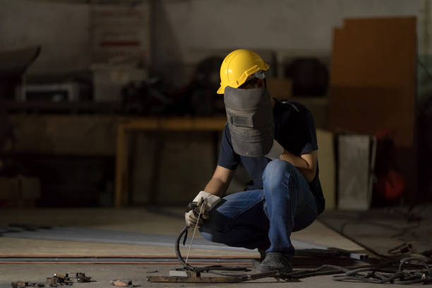 istock Welder or craftsman in a welding mask and welders leathers. 936468866