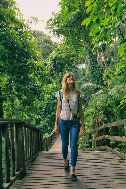 istock Attractive beautiful woman walking through the jungle. 936469186