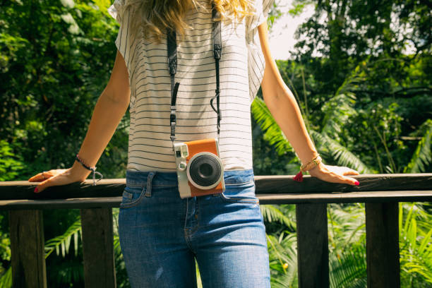 modern fashionable woman posing with old camera in nature. - photographer enjoyment elegance old fashioned imagens e fotografias de stock