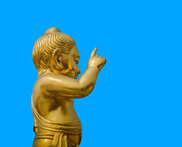 istock Little Buddha Statue Isolated On Blue Background 936470136