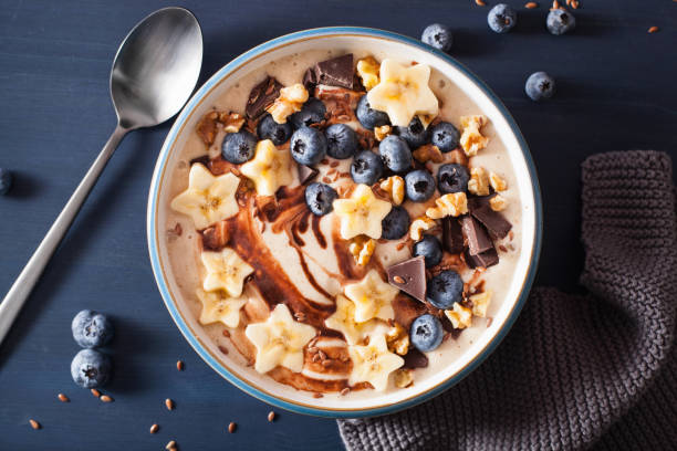 istock healthy banana smoothie bowl with blueberry chocolate walnuts 936472832