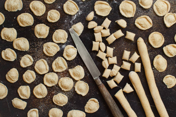 全粒小麦の小麦粉パスタ オレキエッテを作ってください。 - wheat pasta flour italy ストックフォトと画像
