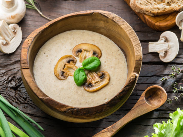 istock Cream-soup with mushrooms on wooden table. 936478328