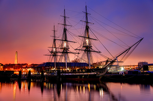Boston, Massachusetts, USA - November 22, 2016: Evening view of the world's oldest commissioned naval vessel still afloat and berthed at Pier 1 of the former Charlestown Navy Yard, at one end of Boston's Freedom Trail