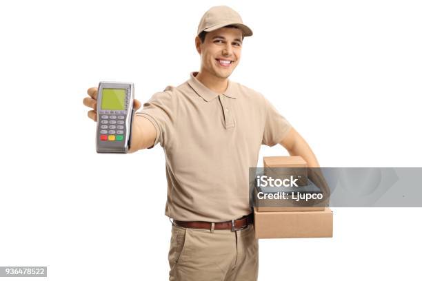 Delivery Man Holding A Payment Terminal And Packages Stock Photo - Download Image Now