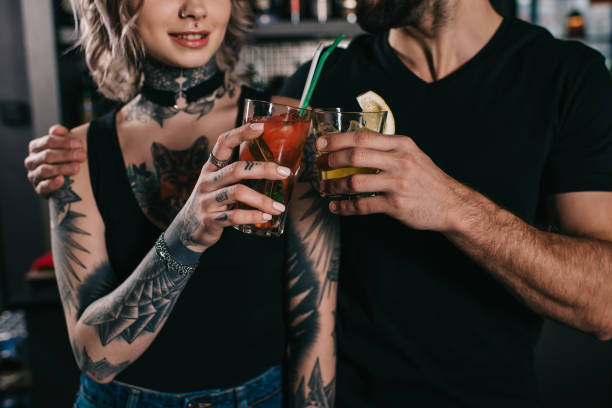 istock cropped image of bartenders clinking with drinks at bar 936478532