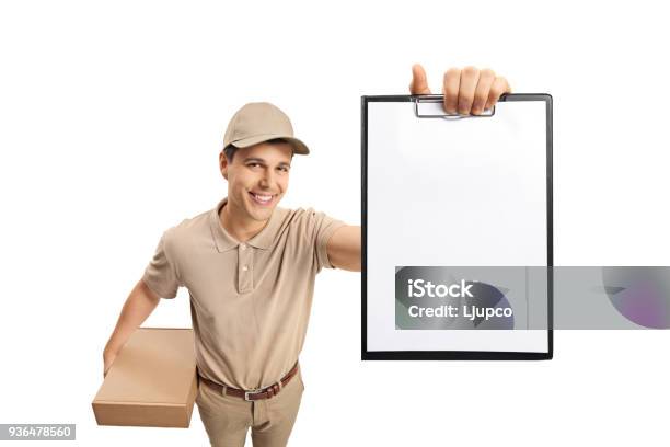 Delivery Guy Showing A Blank Clipboard Stock Photo - Download Image Now - 30-39 Years, Adult, Adults Only