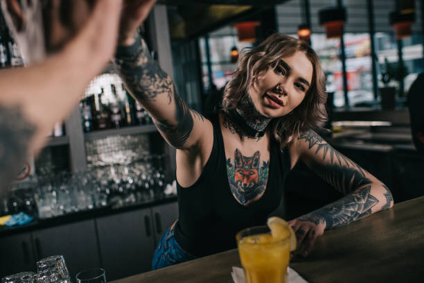 istock cropped image of tattooed bartender giving high five to visitor at bar 936478856