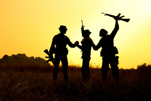 istock Military soldier holding weapons overhead after get victory. 936483188
