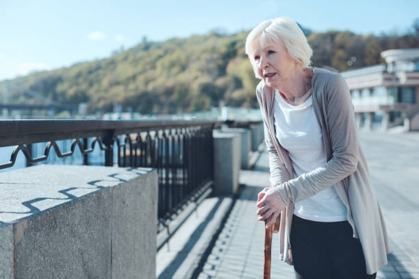 istock Ill elderly lady promenading along the riverwalk 936487974