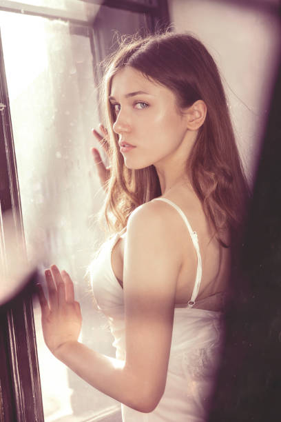 Beautiful Woman in Bra and Denim Shorts Posing in Window · Free Stock Photo