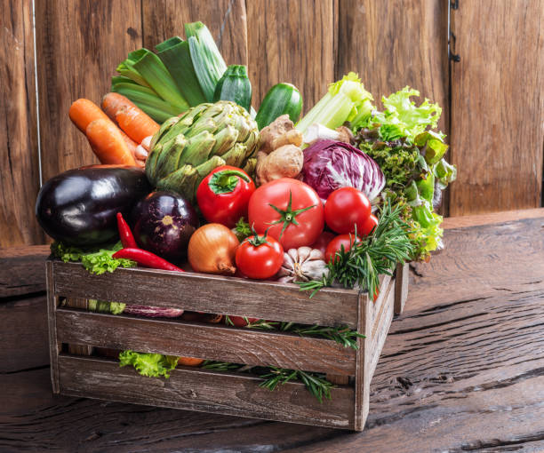 istock Fresh multi-colored vegetables in wooden crate. 936491240