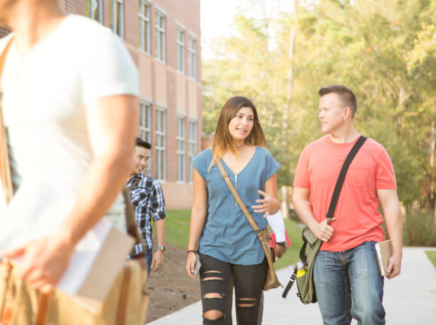 istock College student friends walking to class on university campus. 936491356