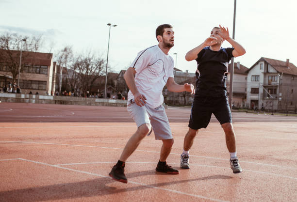 istock Two basketball players playing basketball 936495678