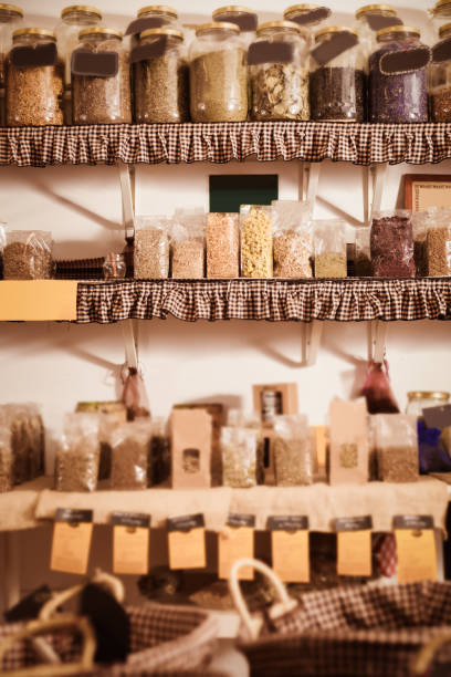 istock Glass cans with many dried spices plants is standing on shelf 936496012
