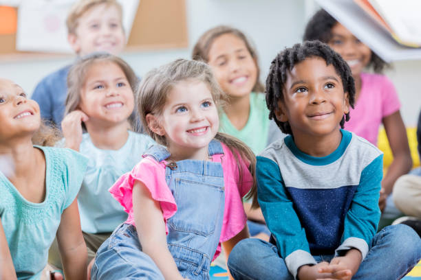 Group of attentive school children during story time
