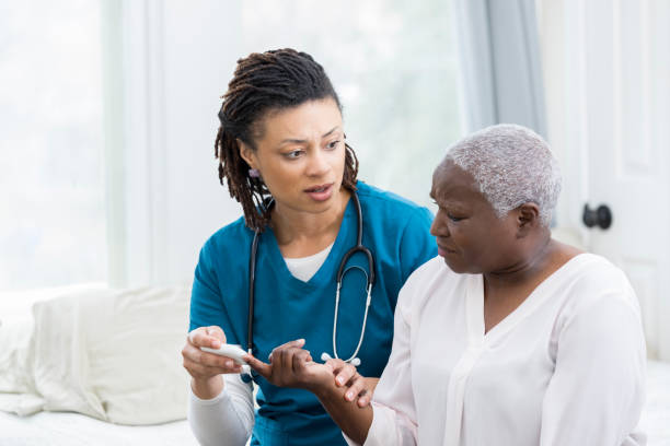 istock Concerned nurse checks patient's blood sugar 936497026