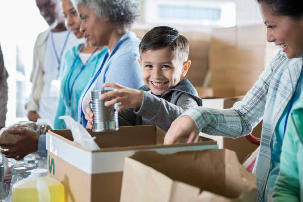 istock Adorable little boy volunteering during food drive 936497134