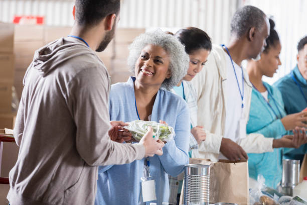 istock Young man donates food during food drive 936497164
