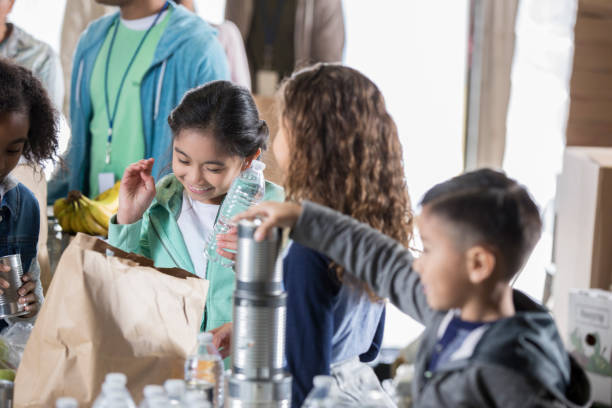istock Children volunteering during food drive 936497172