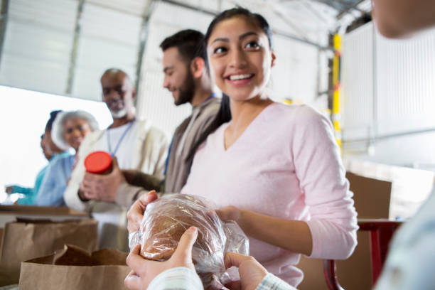 istock Confident young woman volunteering during food drive 936497176