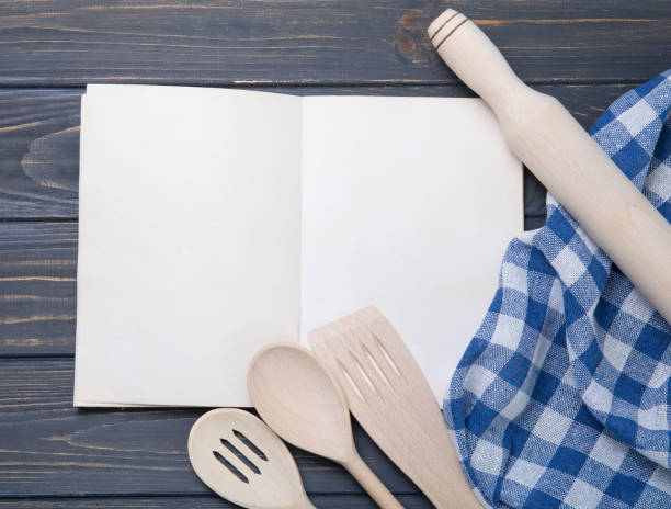 istock Kitchen utensil and notepad over wooden table background 936499572