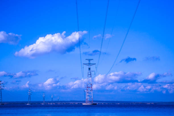 power line across the river - water surface emotional stress shape nature imagens e fotografias de stock