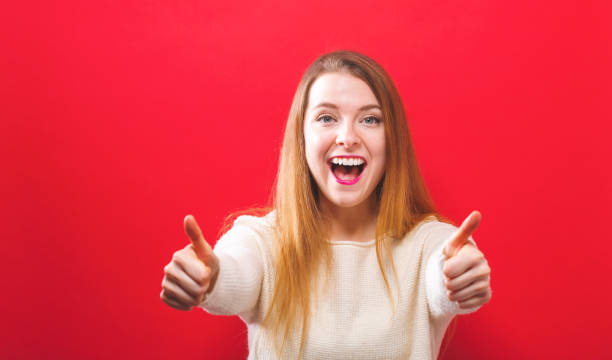 istock Happy young woman giving thumbs up 936504140