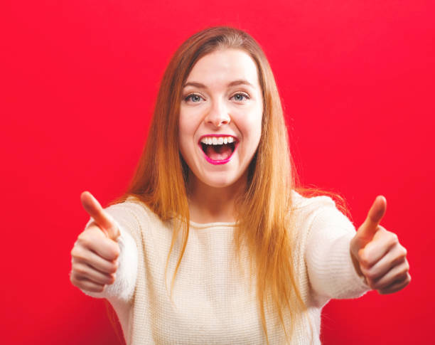 istock Happy young woman giving thumbs up 936504210