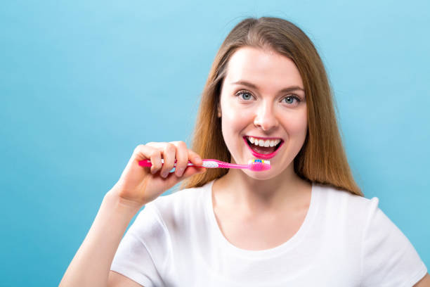 istock Young woman holding a toothbrush 936504608