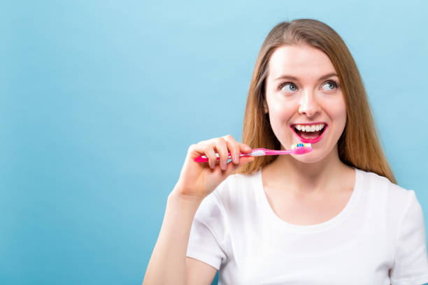 istock Young woman holding a toothbrush 936504630