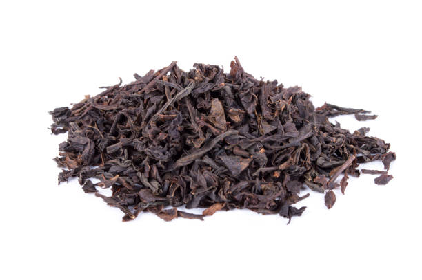 istock Black tea dried leaves isolated on white background 936506238