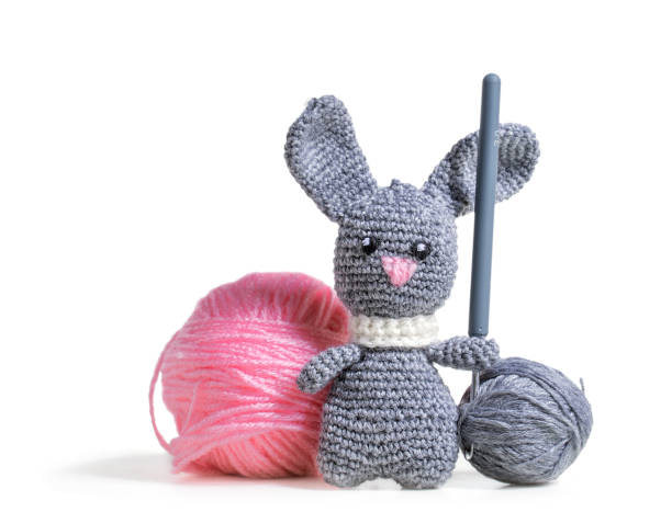 istock Knitted hare amigurumi with tangles of thread 936506610