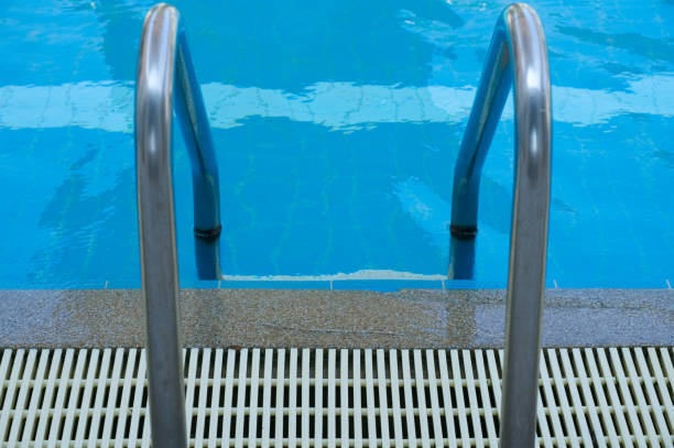 istock Pool stair on top view on blue water in swimming pool 936515700