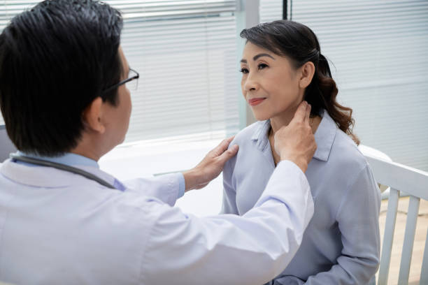 istock Examining Glands of Senior Patient 936516818