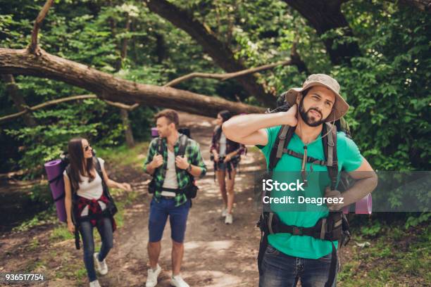 Hard Difficult Tiring And Exhausting Expedition Of Four Friends In Wild Forest In Trail Guy Is Struggling Of A Neck Pain Massaging It Stock Photo - Download Image Now