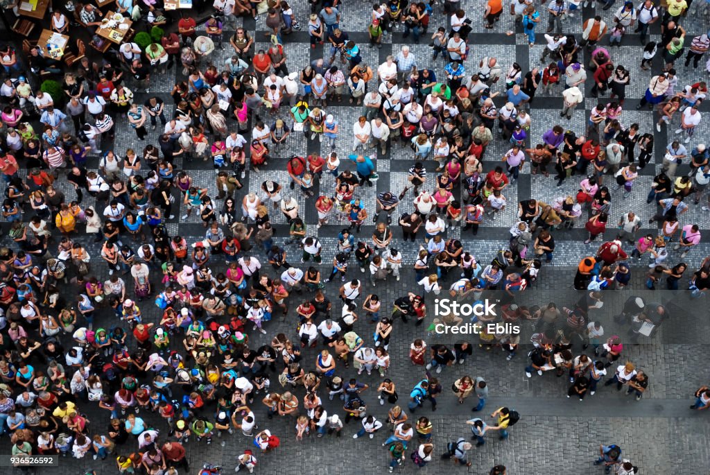 Aerial photograph of people gathered in a square Aerial photograph of tourists visiting the Old Town Square in Prague Crowd of People Stock Photo