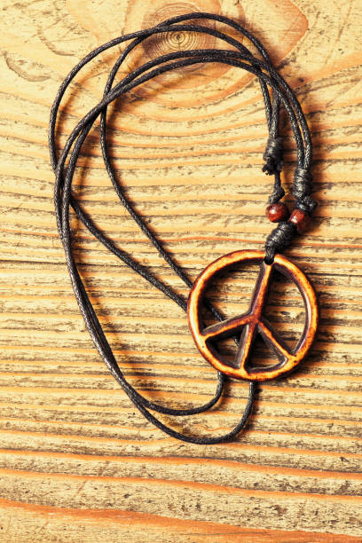 istock Wooden peace symbol on wooden background 936530990