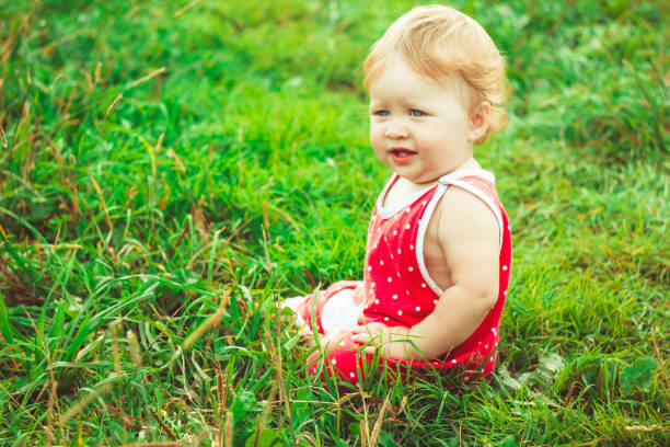 istock The child is sitting on the grass 936533208