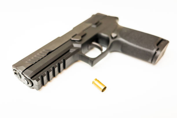 istock Handgun with ammo rounds and smoke 936533592