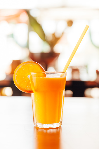 Brazilian fruit caja. Glass of juice on wooden table.