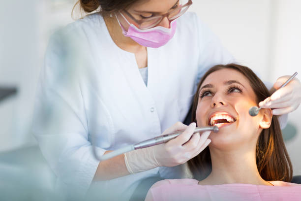 Dentist and patient in dentist office stock photo