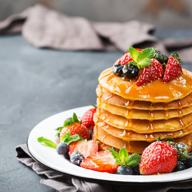 istock Stack of homemade pancakes for breakfast with berries 936538440