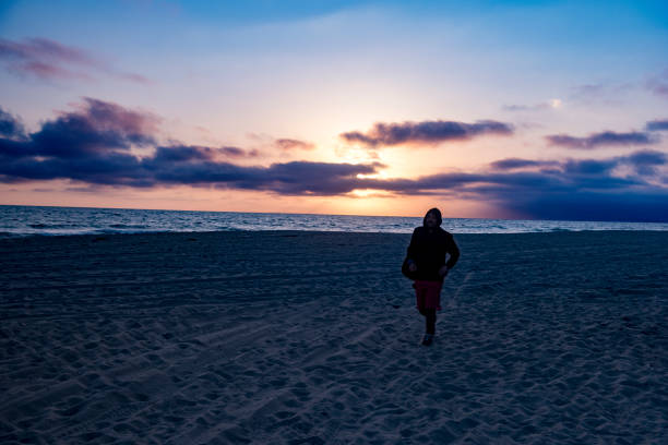 istock man walking on manhattan beach in los angeles 936538586