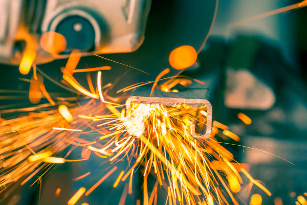 istock Orange sparks flying from metal being cut with electric grinder 936542962